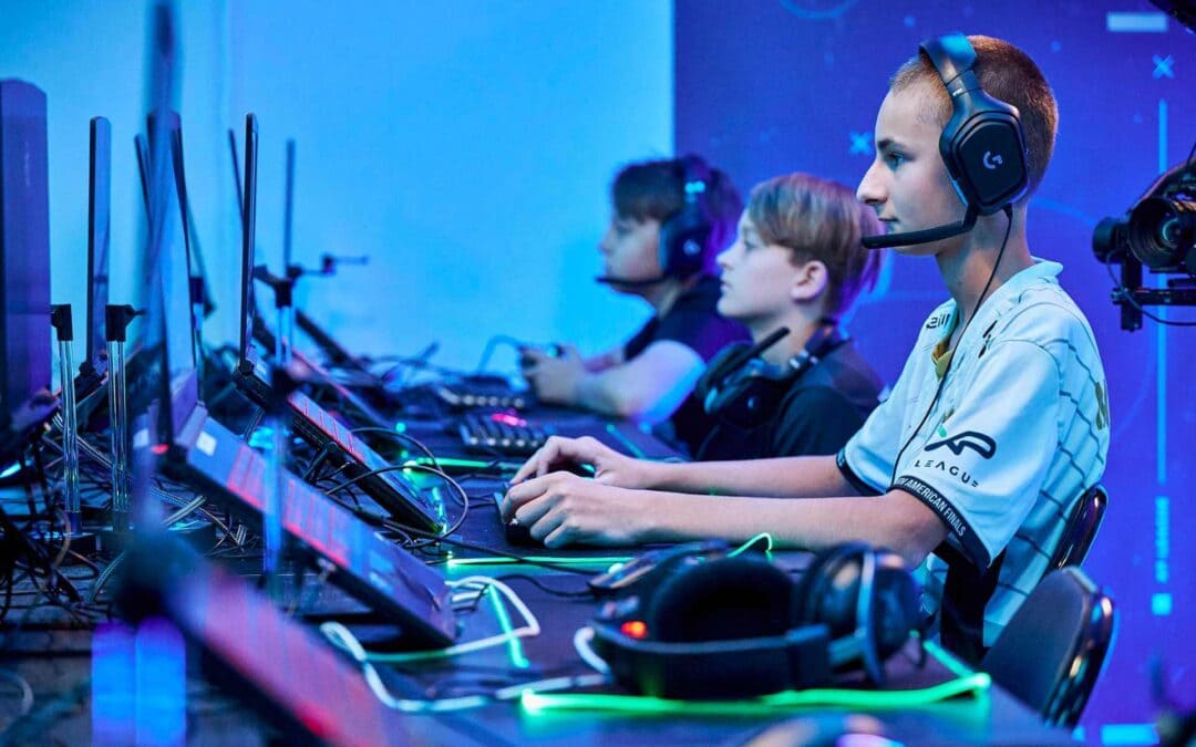 boys playing an online game at laptops